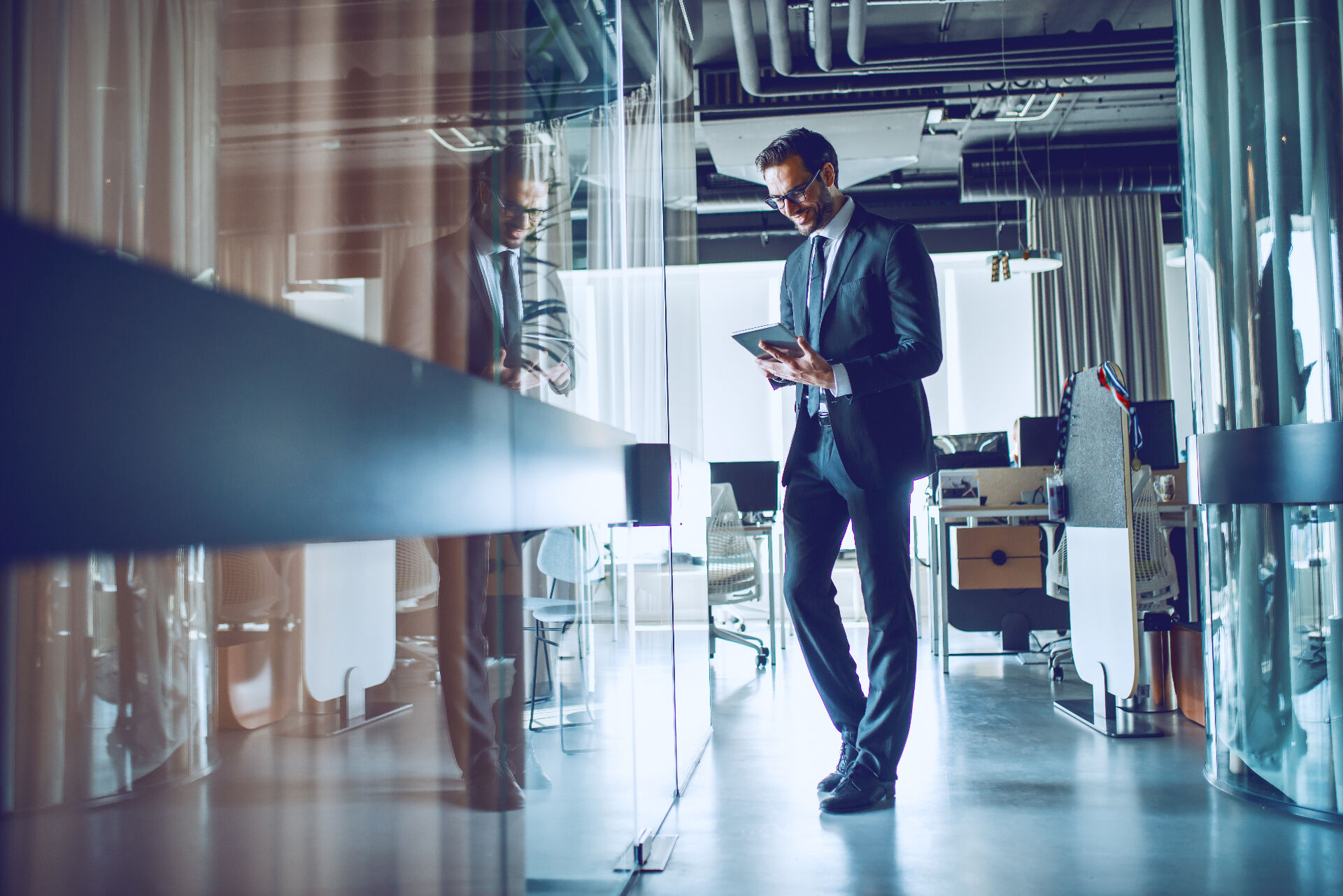Professional reviewing protection status on a tablet in a modern office